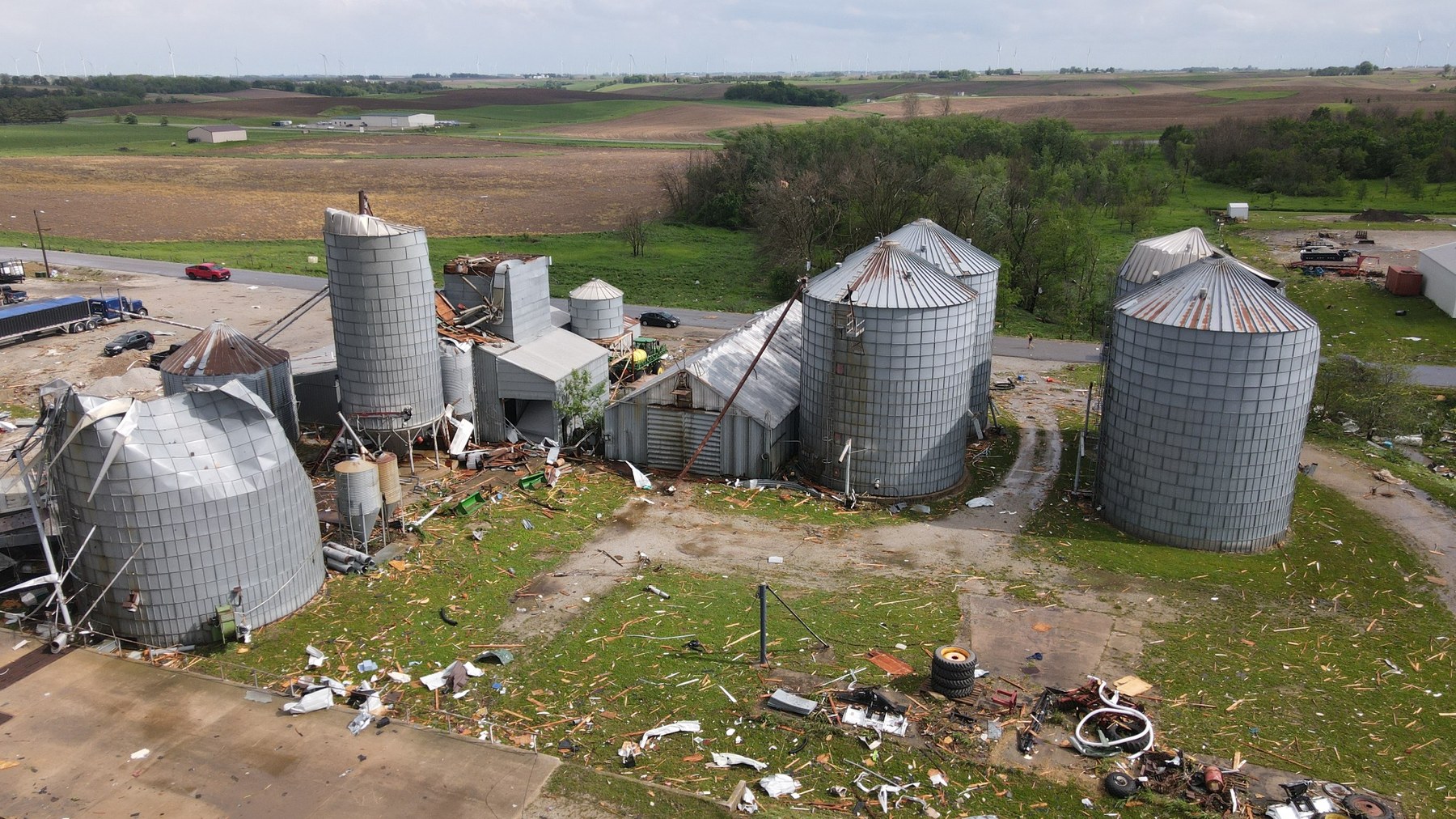 Aerial drone storm damage photo showing damaged grain bins and rural property after severe weather